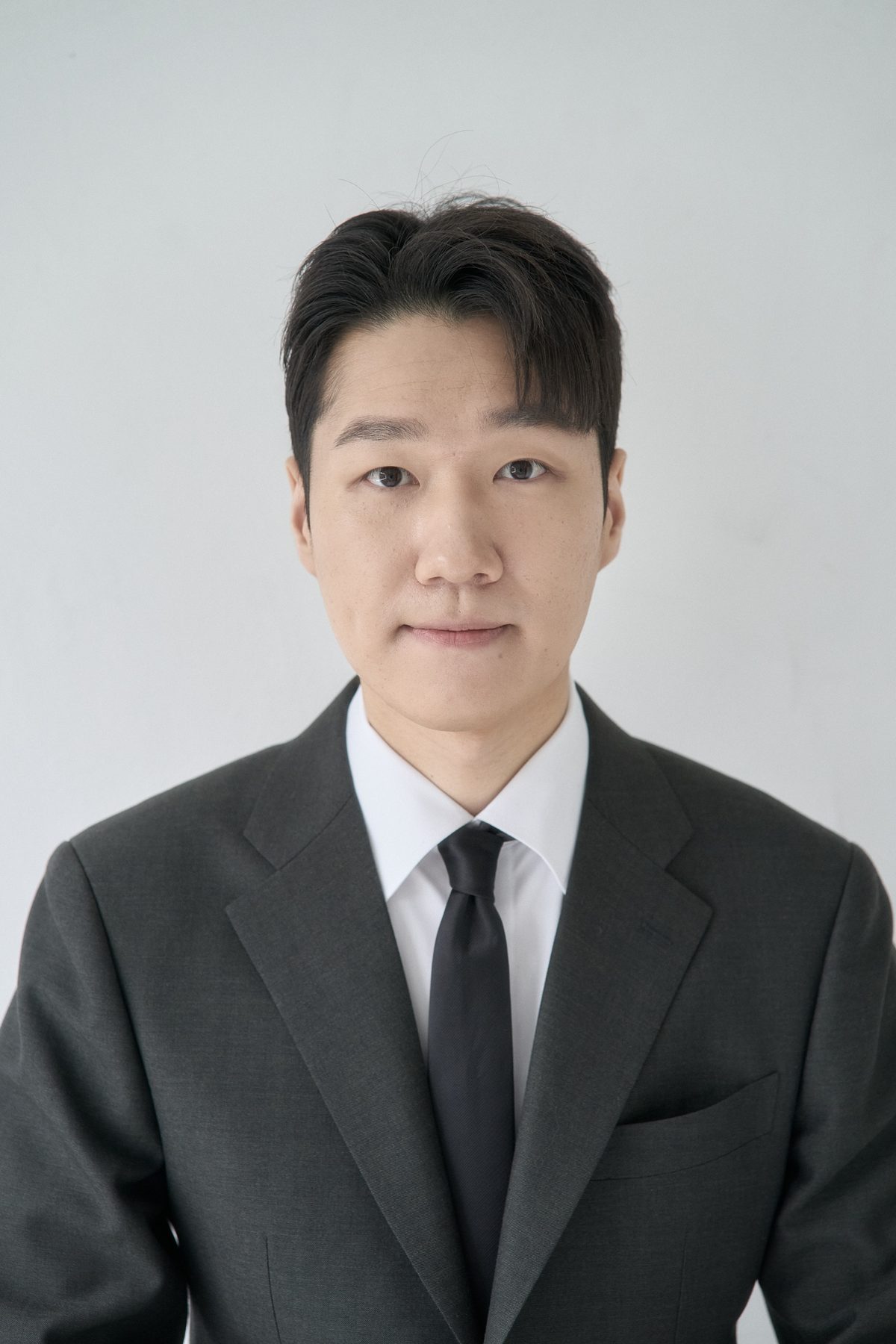Soonjae Kwon, upper-body portrait in a charcoal suit